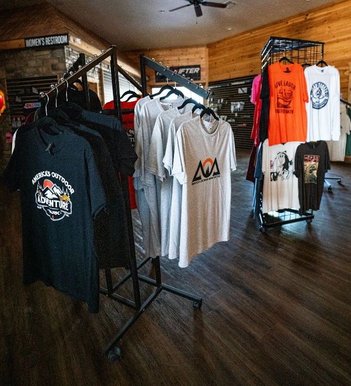 T-shirts displayed on racks in a retail store.